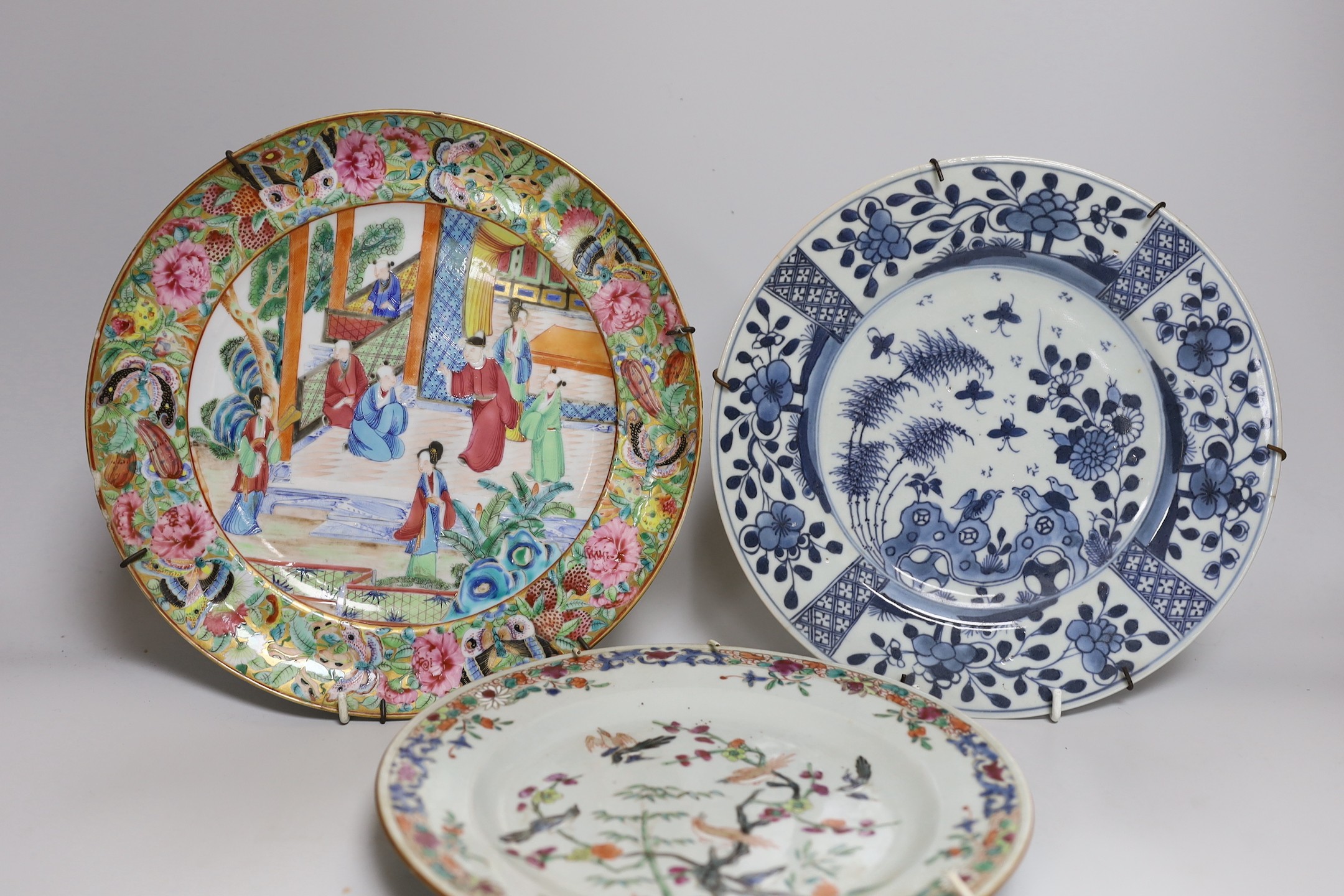 A 19th century Chinese enamelled porcelain dish, 25.4cm and two 18th century Chinese exports porcelain plates (3)